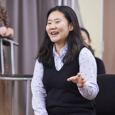 A student gesturing during a discussion